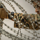 Member of Military using 212 Performance gloves to deploy razor wire