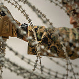 Member of Military using 212 Performance gloves to deploy razor wire